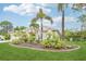Beautiful house with lush landscaping, mature palm trees, and a well-kept lawn at 5988 Viola Rd, Venice, FL 34293