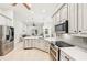 Bright kitchen features stainless appliances, modern cabinetry, and a seamless flow into the living area at 5988 Viola Rd, Venice, FL 34293