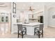 An open-concept kitchen features a breakfast bar with modern chairs and ample counter space at 5988 Viola Rd, Venice, FL 34293