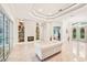 Spacious living room featuring fireplace, tray ceiling, and decorative display shelving at 5988 Viola Rd, Venice, FL 34293