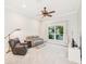 Cozy living room featuring a ceiling fan, comfortable seating, and natural light at 5988 Viola Rd, Venice, FL 34293