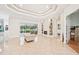 Bright living room with tray ceilings, fireplace and large windows overlooking backyard at 5988 Viola Rd, Venice, FL 34293