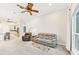 Comfortable living room with ceiling fan, carpeting, and view to a modern kitchen at 5988 Viola Rd, Venice, FL 34293