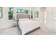 Light-filled bedroom features soft carpet, a large bed, and backyard views at 5988 Viola Rd, Venice, FL 34293