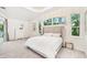Tranquil bedroom featuring soft carpet, a large bed, and lots of natural light at 5988 Viola Rd, Venice, FL 34293