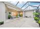 Spacious enclosed patio featuring comfortable seating, a ceiling fan, and sliding glass doors, perfect for outdoor entertaining at 5988 Viola Rd, Venice, FL 34293