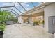 Enclosed patio featuring a hot tub, comfortable seating, and sliding glass doors, creating a perfect outdoor retreat at 5988 Viola Rd, Venice, FL 34293