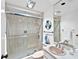 Updated bathroom featuring a glass shower and a decorative nautical theme at 601 Longboat Club Rd # 504S, Longboat Key, FL 34228