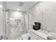Sleek bathroom features a glass-enclosed shower, marbled walls, dual shower heads, and a vanity at 601 Longboat Club Rd # 504S, Longboat Key, FL 34228