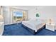 Bright bedroom features a large window with views, a desk, and blue carpeting at 601 Longboat Club Rd # 504S, Longboat Key, FL 34228