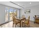 Comfortable dining area with luxury vinyl plank flooring, patio access and comfortable seating for four at 601 Longboat Club Rd # 504S, Longboat Key, FL 34228