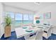 Bright dining room with a white table and chairs set for a meal, offering ocean views at 601 Longboat Club Rd # 504S, Longboat Key, FL 34228