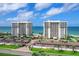 Two condo buildings with beachfront access, as seen from an elevated view at 601 Longboat Club Rd # 504S, Longboat Key, FL 34228