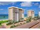 Exterior image shows condo buildings with the beach visible in the background at 601 Longboat Club Rd # 504S, Longboat Key, FL 34228