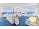 Bright living room with ocean views from large windows and modern furnishings at 601 Longboat Club Rd # 504S, Longboat Key, FL 34228
