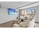 Bright living room features stylish white sofas, wood floors, and expansive windows at 601 Longboat Club Rd # 504S, Longboat Key, FL 34228