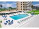 Exterior shot showing sparkling pool, lounge chairs, and landscaping at 601 Longboat Club Rd # 504S, Longboat Key, FL 34228
