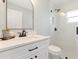 Bright bathroom featuring a glass-enclosed shower, white vanity with black hardware, and modern fixtures at 6140 Bobby Jones Ct, Palmetto, FL 34221