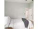 Bright bedroom showcasing an open door, hardwood floors, and a comfortable bed with soft furnishings at 6140 Bobby Jones Ct, Palmetto, FL 34221