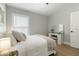 Bright bedroom with natural light features a vanity with a stool and a comfortable bed with a neutral color scheme at 6140 Bobby Jones Ct, Palmetto, FL 34221