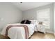 Comfortable bedroom with neutral color palette, hardwood floors, and cozy bedding at 6140 Bobby Jones Ct, Palmetto, FL 34221
