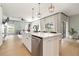 Open-concept kitchen featuring an island with a stainless steel dishwasher and modern fixtures at 6140 Bobby Jones Ct, Palmetto, FL 34221