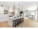 Modern kitchen featuring island with seating, white cabinets, and open concept to the living space at 6140 Bobby Jones Ct, Palmetto, FL 34221