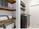Organized laundry room with custom shelving and modern appliances at 6140 Bobby Jones Ct, Palmetto, FL 34221