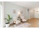 Bright living area featuring stylish seating, natural light, neutral paint, and wood laminate flooring at 6140 Bobby Jones Ct, Palmetto, FL 34221