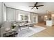 Spacious living room with a large sectional sofa, accent tables, and seamless connection to the kitchen at 6140 Bobby Jones Ct, Palmetto, FL 34221