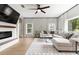 Comfortable living room featuring a fireplace, large sectional sofa, and expansive windows at 6140 Bobby Jones Ct, Palmetto, FL 34221