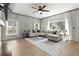 Inviting living room with a fireplace, large sectional sofa, neutral tones, and natural light at 6140 Bobby Jones Ct, Palmetto, FL 34221