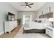 Bright main bedroom showcasing a large window, dresser, and ceiling fan at 6140 Bobby Jones Ct, Palmetto, FL 34221