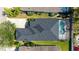 Overhead view of a home with a screened-in pool, showcasing the roof, landscaping, and backyard layout at 6213 Willet Ct, Lakewood Ranch, FL 34202