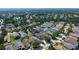 Aerial view of a suburban neighborhood featuring the property surrounded by mature trees and a pond at 6213 Willet Ct, Lakewood Ranch, FL 34202