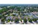 Aerial view of a suburban neighborhood featuring the property surrounded by mature trees and a pond at 6213 Willet Ct, Lakewood Ranch, FL 34202