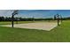 Outdoor basketball court with multiple hoops on a sunny day, surrounded by green fields at 6213 Willet Ct, Lakewood Ranch, FL 34202