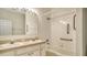 Bathroom featuring dual sinks, spacious vanity, bathtub and shower with handrails for safety at 6213 Willet Ct, Lakewood Ranch, FL 34202