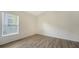 Bright, spacious bedroom with wood-look floors and a large window at 6213 Willet Ct, Lakewood Ranch, FL 34202