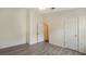 Light-filled bedroom with wood-look floors, ceiling fan, and entry to another room at 6213 Willet Ct, Lakewood Ranch, FL 34202