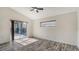 Bedroom featuring sliding glass doors, wood flooring, and window with blinds at 6213 Willet Ct, Lakewood Ranch, FL 34202