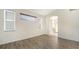 Bedroom with wood floors, two windows with blinds, and an en-suite bathroom at 6213 Willet Ct, Lakewood Ranch, FL 34202