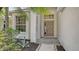 Close-up showcasing the front door, large windows, and landscaped garden beds at the entrance at 6213 Willet Ct, Lakewood Ranch, FL 34202