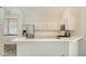 Modern kitchen with stainless steel appliances, white cabinetry, and a breakfast bar area at 6213 Willet Ct, Lakewood Ranch, FL 34202