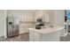 Bright kitchen featuring stainless steel appliances, white cabinets, and a countertop with a breakfast bar at 6213 Willet Ct, Lakewood Ranch, FL 34202