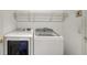 Modern laundry room with front loading washer and dryer plus wire shelving for organization at 6213 Willet Ct, Lakewood Ranch, FL 34202