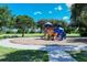 Enjoyable playground with swings, slides, and seating areas surrounded by trees and beautiful grassy lawns at 6213 Willet Ct, Lakewood Ranch, FL 34202
