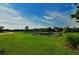 Scenic view of a pond with lily pads surrounded by lush green grass, creating a serene natural environment at 6213 Willet Ct, Lakewood Ranch, FL 34202