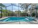 The pool is enclosed and offers a spa with stunning blue tile and tropical landscaping at 6213 Willet Ct, Lakewood Ranch, FL 34202