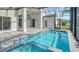 The pool is enclosed and offers a spa with stunning blue tile and tropical landscaping at 6213 Willet Ct, Lakewood Ranch, FL 34202